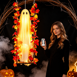 Woman holding the remote control next to the glowing BooLuma ghost swing at night